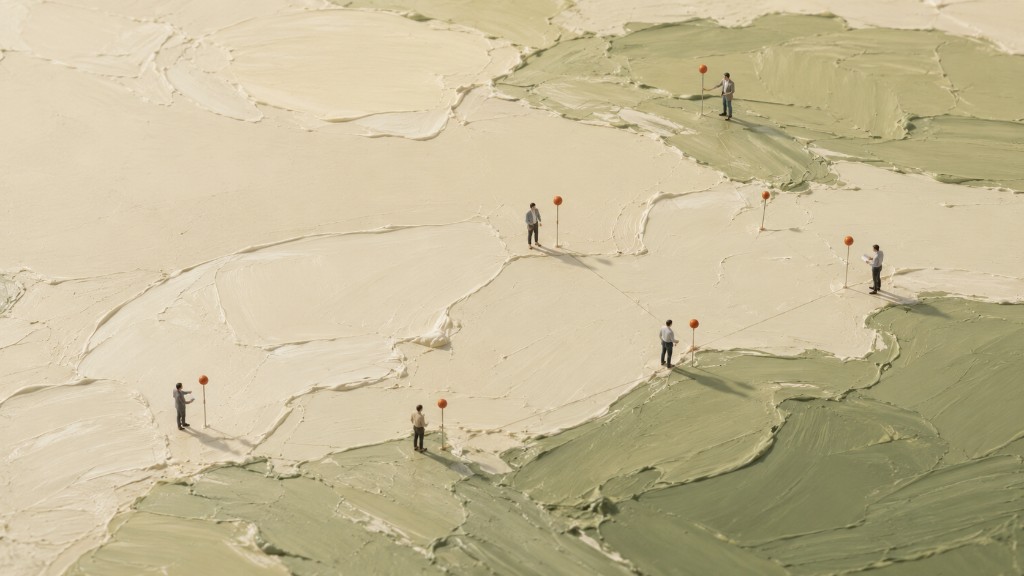 Strategic planners marking locations across a textured landscape map